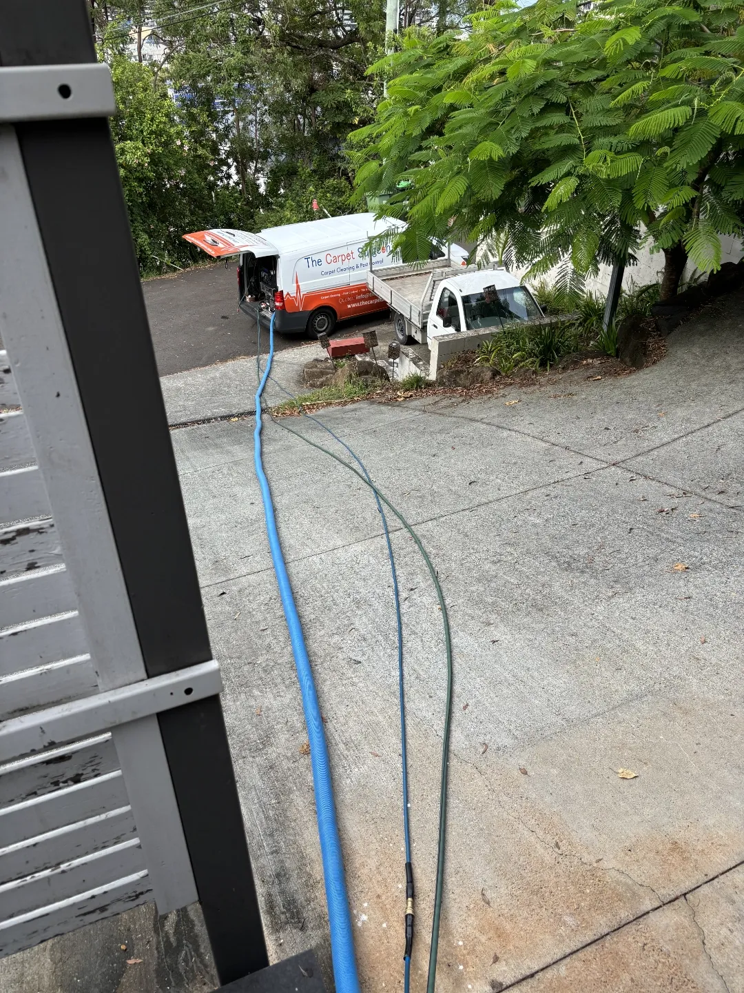 The Carpet Surgeon Gold Coast demonstrating a long hose run during a carpet cleaning service.